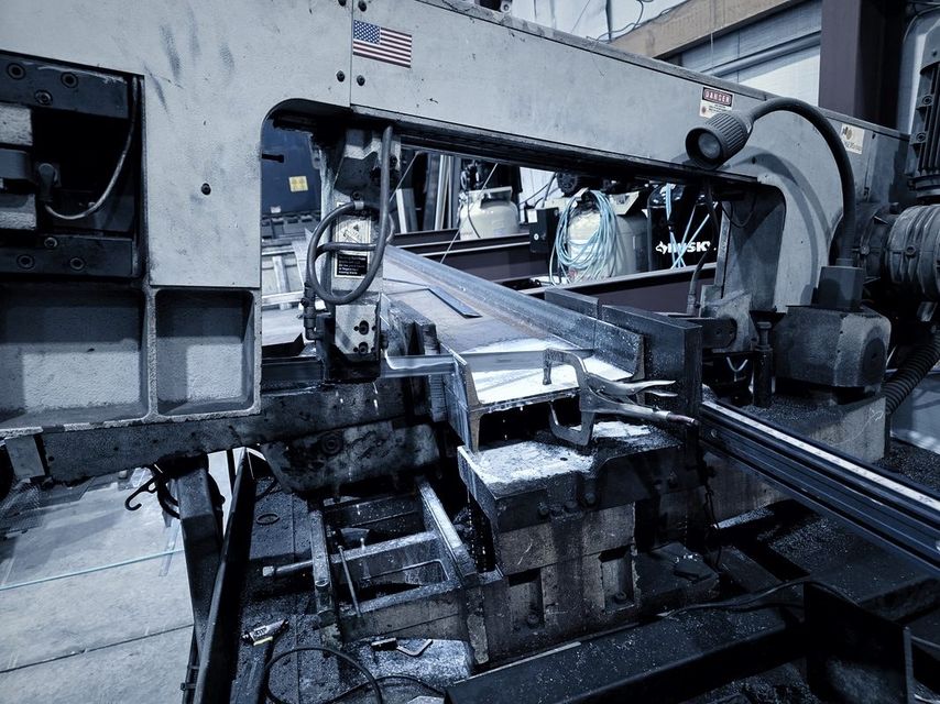 A length of steel clamped in the band saw