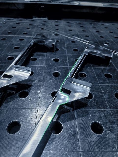 Long formed sheet metal parts with tabs on the fixture table
