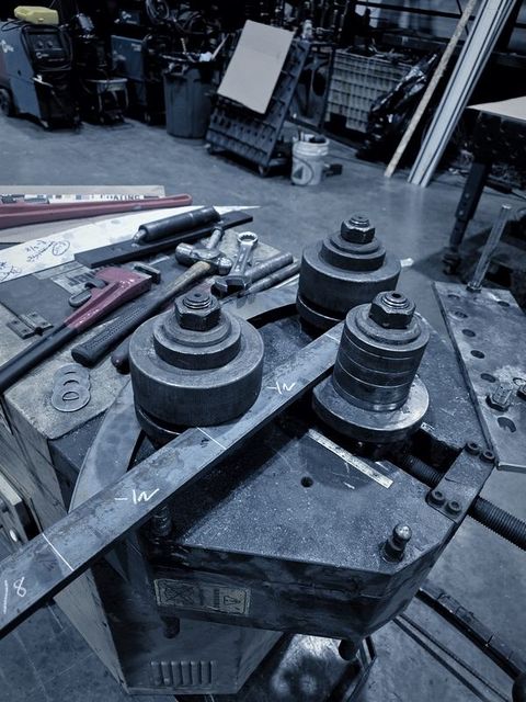 A flat bar passes between the dies of the bar roller