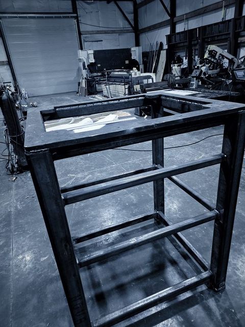 A welded steel tube frame standing on the shop floor